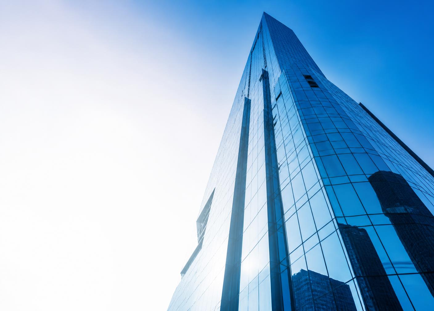 Modern glass office tower seen from below